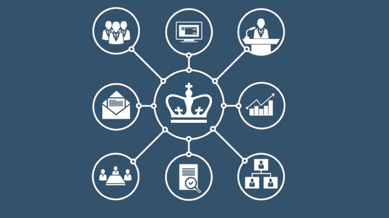 Network diagram with a central crown icon connected to eight surrounding circular icons representing key organizational functions: team collaboration, computer presentation, speaker at podium, email communications, analytics chart, conference meeting, document verification, and organizational hierarchy structure.