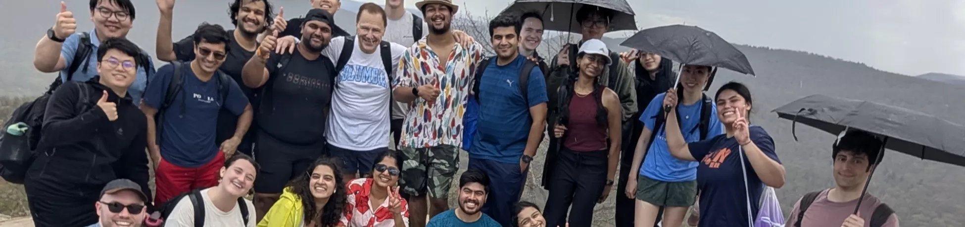 Person taking self portrait in front of a group of people